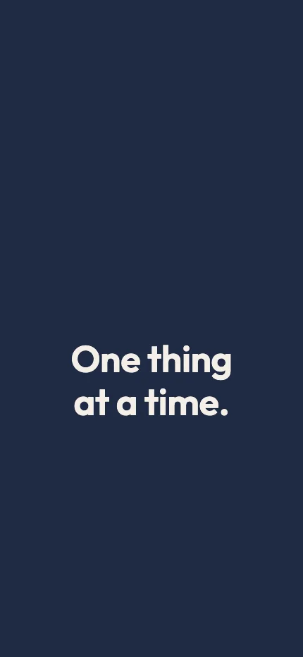 Intention iPhone lock screen wallpaper with the words “One thing at a time.”
