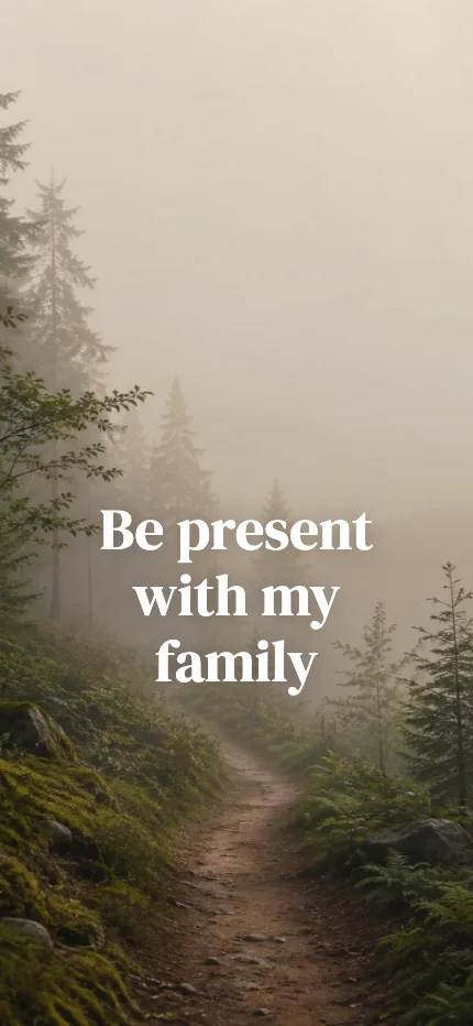 Intention iPhone lock screen wallpaper with the words “Be present with my family” over a forest path photo