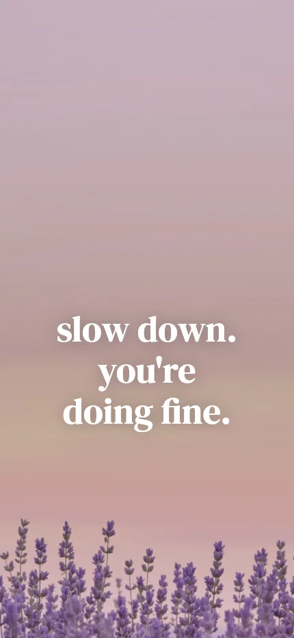 Calm iPhone lock screen wallpaper with the words “slow down. / you're doing fine.” over a lavender photo
