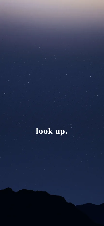 Calm iPhone lock screen wallpaper with the words “look up.” over a starry night photo